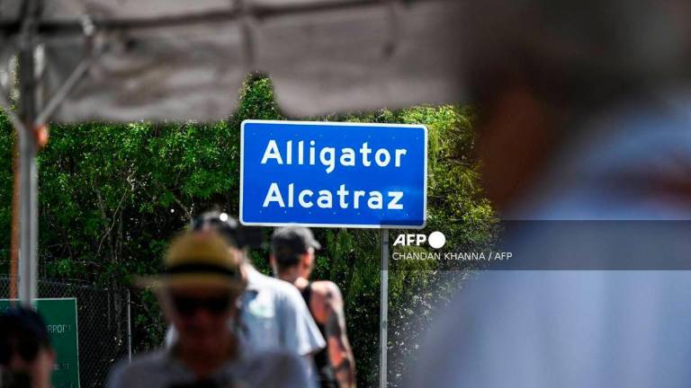 People attend Irish priest Father Frank O’Loughlin’s Diamond Jubilee Mass in solidarity with those detained, outside the immigrant detention center known as “Alligator Alcatraz” at the Dade-Collier Training and Transition Airport in Ochopee, Florida, on August 16, 2025. (Photo by CHANDAN KHANNA / AFP)
