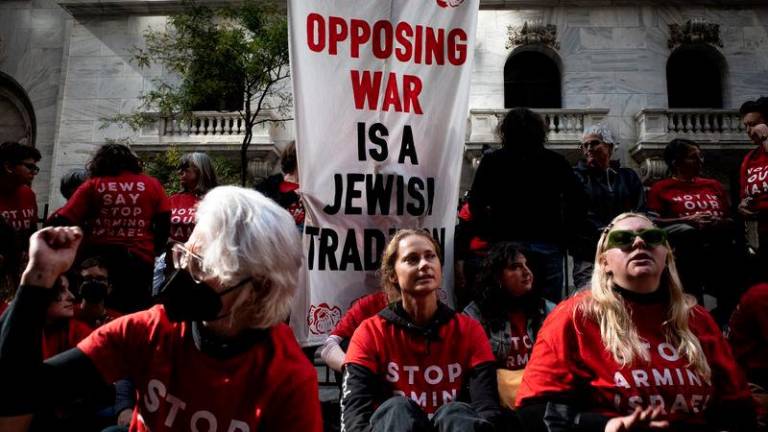 Pro-Palestinian protestors gather at the New York Stock Exchange (NYSE) to protest the ongoing war between Israel and Hamas in New York City, U.S., October 14, 2024. REUTERS.