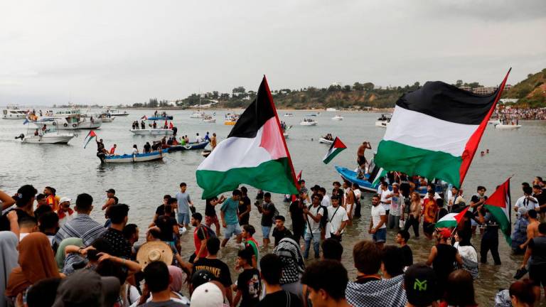 People gather, as they await the departure of the Global Sumud flotilla at the port of Sidi Bou Said, bound to leave for Gaza from Tunisia, along with other Tunisian boats, in a major act of solidarity with the Palestinian people against the Israeli blockade, Sidi Bou Said, Tunisia, September 10, 2025. REUTERS/Zoubeir Souissi