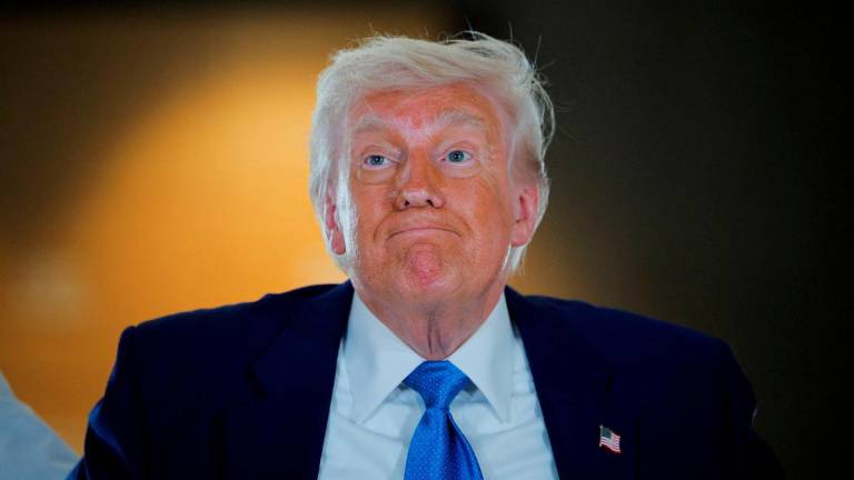 U.S. President Donald Trump reacts as he visits the Abrahamic Family House during the final stop of his Gulf visit, in Abu Dhabi, United Arab Emirates, May 16, 2025. - REUTERSPIX