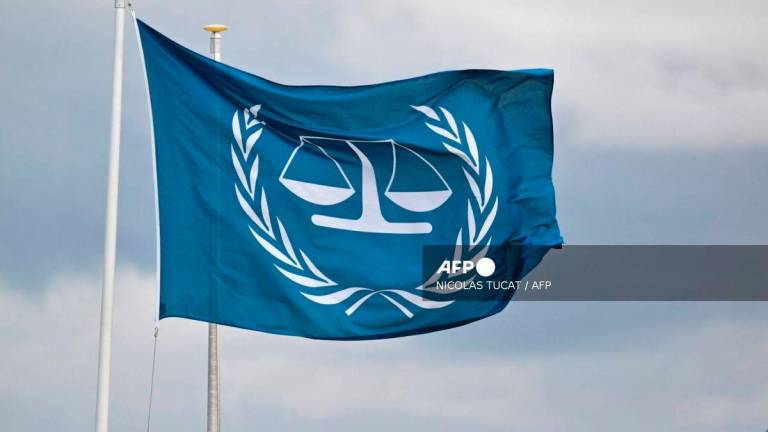 This photograph taken on March 14, 2025 shows a flag fluttering outside the International Criminal Court (ICC) in The Hague. - AFP
