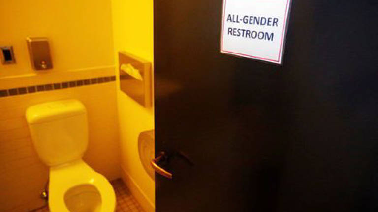 Obama issues school rules on transgender bathroom use