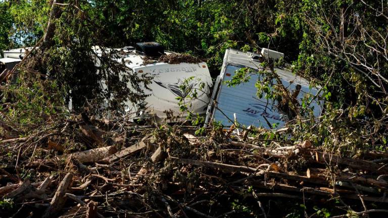 Destroyed motorhomes lay on the bank of the Guadalupe River on July 8, 2025 in Center Point, Texas. - Jim Vondruska/Getty Images/AFP