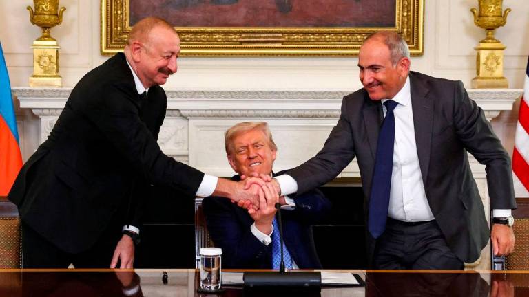 U.S. President Donald Trump holds the hands of Azerbaijan’s President Ilham Aliyev and Armenia’s Prime Minister Nikol Pashinyan as they shake hands between each other during a trilateral signing event. Reuterspix