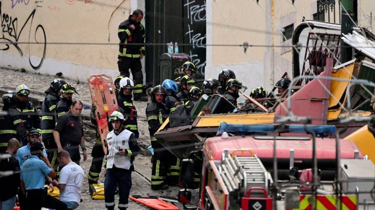 First responders work at the site of an accident involving Lisbon's Gloria funicular, a popular tourist attraction, which derailed and crashed, resulting in fatalities and injuries, according to authorities, in Lisbon, Portugal, September 3, 2025. - REUTERSPIX