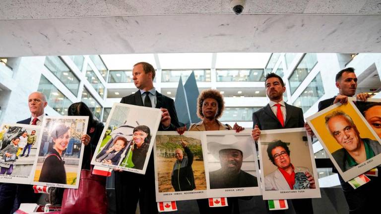 Family members hold photographs of Boeing 737 MAX crash victims lost in two deadly 737 MAX crashes that killed 346 people as they arrive for Boeing CEO Dennis Muilenburg’s testimony. October 29, 2019. REUTERSpix