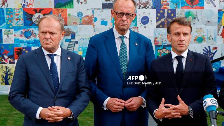 (FILES) (From L) Poland's Prime Minister Donald Tusk, Germany's Chancellor Friedrich Merz and France's President Emmanuel Macron. - Ludovic MARIN / AFP