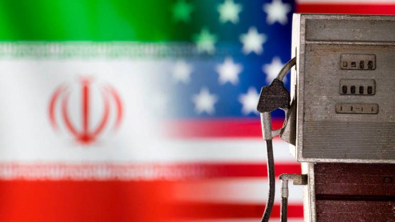 Model of petrol pump is seen in front of U.S. and Iran flag colors in this illustration created on March 25, 2022. REUTERSpix