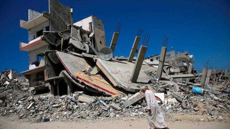 A Palestinian man walks past the rubble of a house destroyed in the Israel’s military offensive, amid the Israel-Hamas conflict, in Khan Younis, in the southern Gaza Strip, September 26, 2024. - REUTERSpix