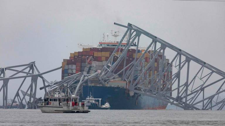 Workers continue to investigate and search for victims after the cargo ship Dali collided with the Francis Scott Key Bridge causing it to collapse yesterday, on March 27, 2024 in Baltimore, Maryland/AFPPix