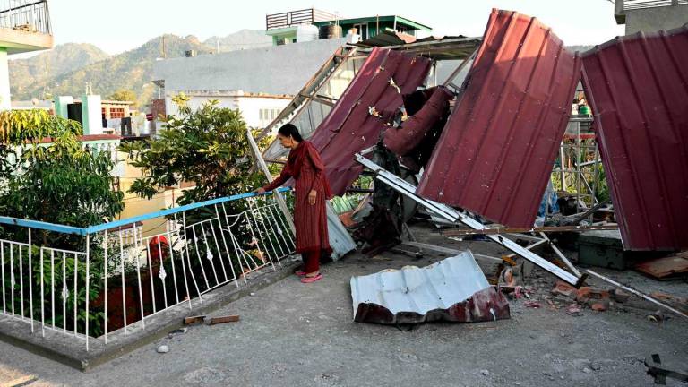 A woman stands at her damaged home after Pakistan launched missiles in Kashmir’s Poonch, on May 14, 2025. Tens of thousands of people living near the border of Indian-administered Kashmir fled as the nuclear-armed rivals fought a four-day conflict from May 7. AFPpix