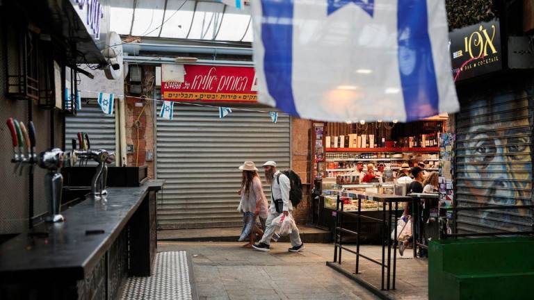 People shop in the main market as Israelis prepare against retaliation by Iran following an Israeli strike, in Jerusalem, June 13, 2025. - REUTERSPIX