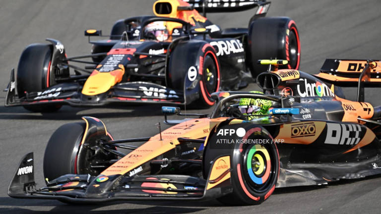 McLaren's British driver Lando Norris (down) and RB's Japanese driver Yuki Tsunoda drive during the second practice session at the Hungaroring race track near Budapest, Hungary, on August 1, 2025, ahead of the Formula One Hungarian Grand Prix. - AFP