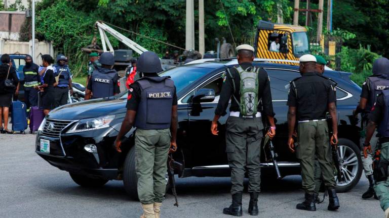 Police officers are seen conducting checks on vehicles at the Federal High court in Abuja, Nigeria October 21, 2021. REUTERSpix