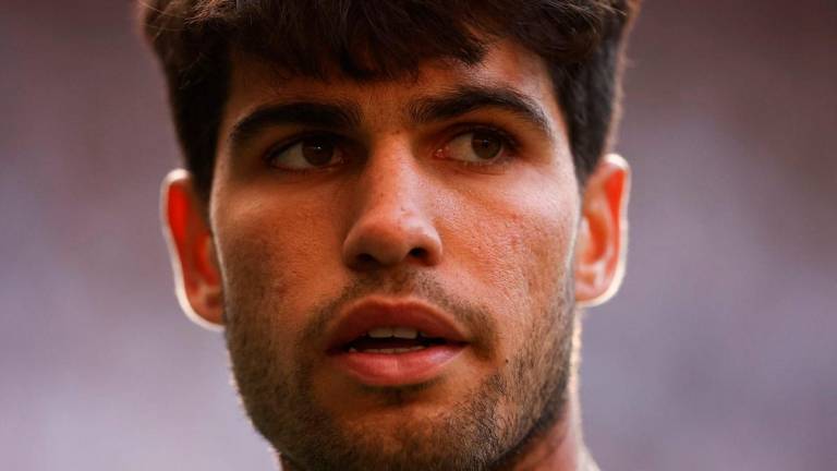 Spain’s Carlos Alcaraz reacts as he plays against Germany’s Jan-Lennard Struff during their men’s singles third round tennis match on the fifth day of the 2025 Wimbledon Championships at The All England Lawn Tennis and Croquet Club in Wimbledon, southwest London, on July 4, 2025- AFP