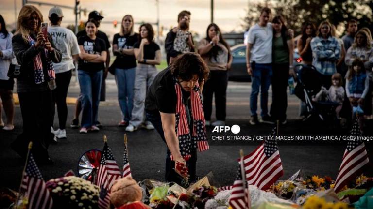 Mourners place flowers outside a memorial for political activist Charlie Kirk on the grounds of Utah Valley University on September 13, 2025 in Orem, Utah. Kirk, CEO and co-founder of Turning Point USA, was shot and killed on Wednesday while he was speaking at an event for his “American Comeback Tour” on the campus. Chet Strange/Getty Images/AFP (Photo by Chet Strange / GETTY IMAGES NORTH AMERICA / Getty Images via AFP)