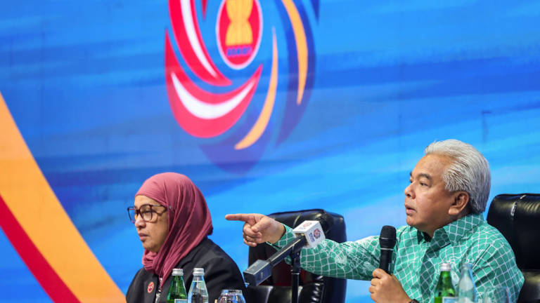 Foreign Ministry Secretary-General Datuk Seri Amran Mohamed Zin speaks during the media briefing for the 58th ASEAN Foreign Ministers’ Meeting (AMM) and related meetings at the Kuala Lumpur Convention Centre (KLCC) today. Also present ASEAN Director-General Datuk Zanariah Zainal Abidin (left). - BERNAMA