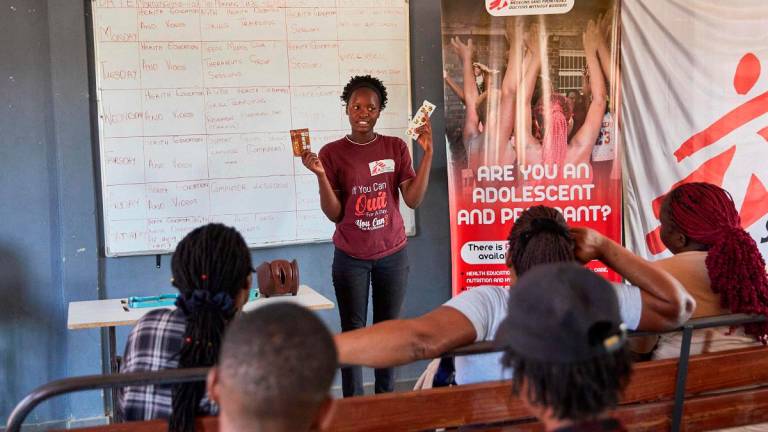Ever Itai Ndondovedzai, a peer educator with Doctores Without Borders (MSF), presents to sex workers a talk on sexual reproductive health and how to properly use a condom in the informal settlement of Epworth in Harare on August 28, 2025. - Jekesai NJIKIZANA / AFP