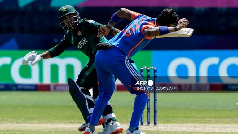 India's Hardik Pandya (R) tries to throw the ball past Pakistan's Usman Khan during the ICC men's Twenty20 World Cup 2024 group A cricket match between India and Pakistan at Nassau County International Cricket Stadium in East Meadow, New York on June 9, 2024. - TIMOTHY A. CLARY / AFP