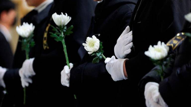 Nuns pray at a memorial altar for the victims of the Jeju Air crash at Muan International Airport, at Muan Sports Park in Muan - REUTERSpix