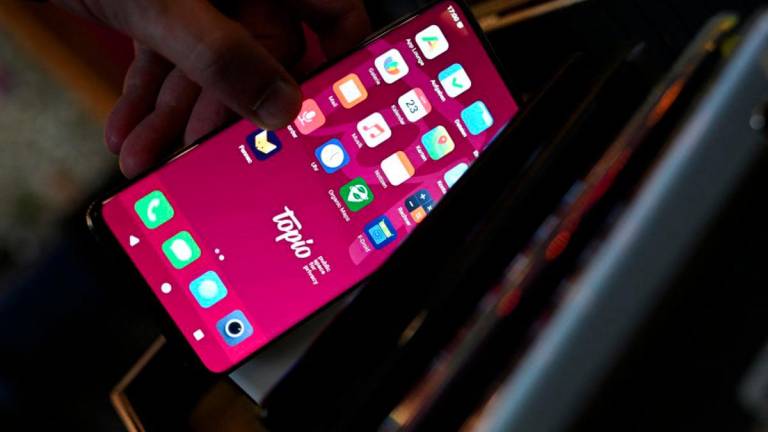 An alternative mobile operating system smartphone is pictured at the Topio organization’s market stall, which offers support for the transition to alternative operating systems for smartphones, tablets, and laptops, moving away from major tech companies like Google and Apple, in Berlin, Germany, April 23, 2025. - REUTERSPIX