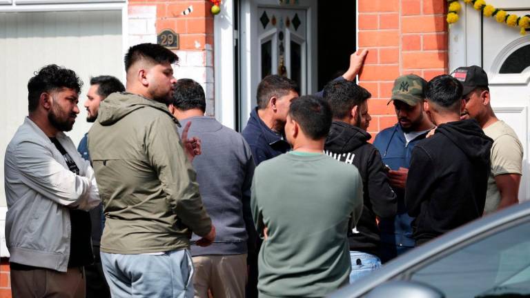 Members of local community stand outside the family home of Ramesh Viswashkumar, a British survivor of the London-bound Air India aircraft crash near Ahmedabad Airport in India, in Leicester, Britain, June 13, 2025. - REUTERSPIX