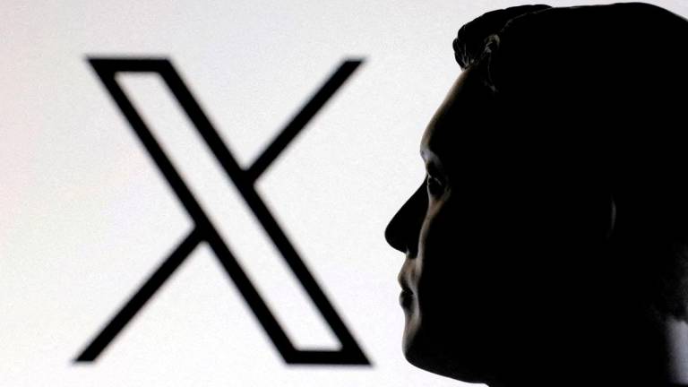 FILE PHOTO: A 3D-printed miniature model of Elon Musk and the X logo are seen in this illustration taken January 23, 2025. REUTERS
