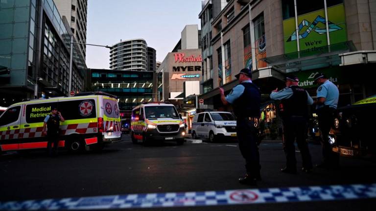 Emergency service workers are seen near Bondi Junction after multiple people were stabbed inside the Westfield Bondi Junction shopping centre in Sydney, April 13, 2024. AAP Image/Steven Saphore via REUTERS ATTENTION EDITORS - THIS IMAGE WAS PROVIDED BY A THIRD PARTY. NO RESALES. NO ARCHIVE. AUSTRALIA OUT. NEW ZEALAND OUT. NO COMMERCIAL OR EDITORIAL SALES IN NEW ZEALAND. NO COMMERCIAL OR EDITORIAL SALES IN AUSTRALIA.