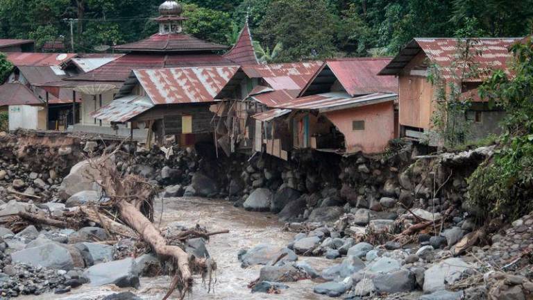 Damaged houses are seen after flash floods and cold lava flow from a volcano in Tanah Datar, West Sumatra, on May 12, 2024. - AFPPIX