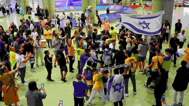 Maccabi Tel-Aviv fans carry flags as they wait for the arrival of their friends and family members from Amsterdam, at the Ben Gurion International Airport on the outskirts of Tel Aviv. AFPPIX