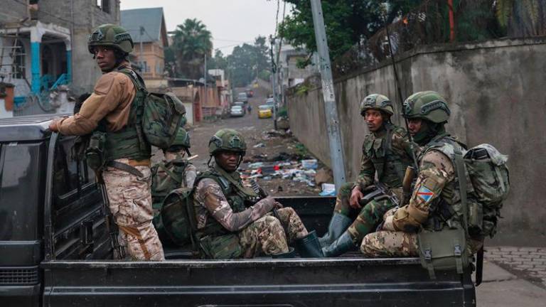 Members of the M23 armed group ride in a pickup truck during a patrol in Goma on January 29, 2025. Rwanda-backed fighters controlled almost all of the DR Congo city of Goma on January 29, 2025 where residents were re-emerging after days of deadly fighting and Angola urged leaders of both countries to urgently hold peace talks. After intense fighting that saw the M23 armed group and Rwandan troops seize the city's airport and key sites, calm returned to the mineral trading hub. (Photo by AFP)