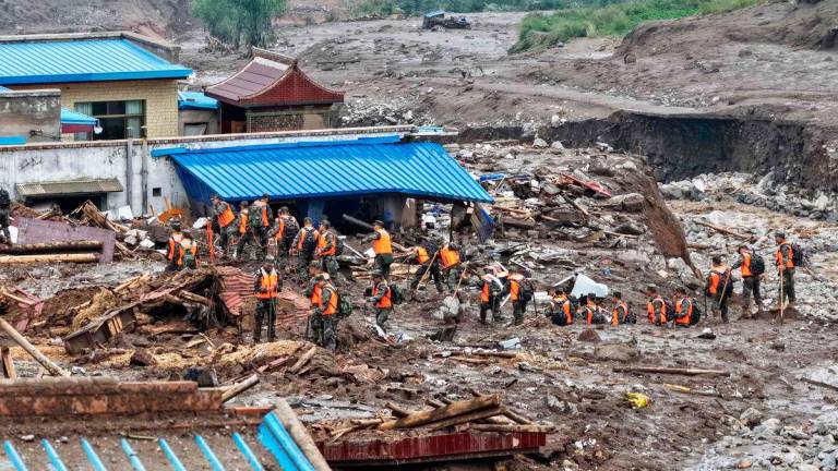 Rescue workers search for survivors after a flash flood in Yuzhong county, in China’s northwest Gansu province on August 8, 2025 - AFP