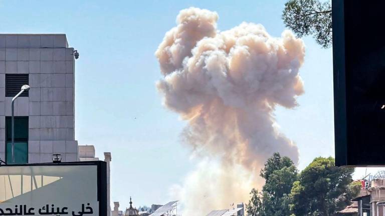 Smoke billows following Israeli strikes near the Syrian army and defence ministry headquarters in Damascus on July 16, 2025. (Photo by Rami al SAYED / AFP)
