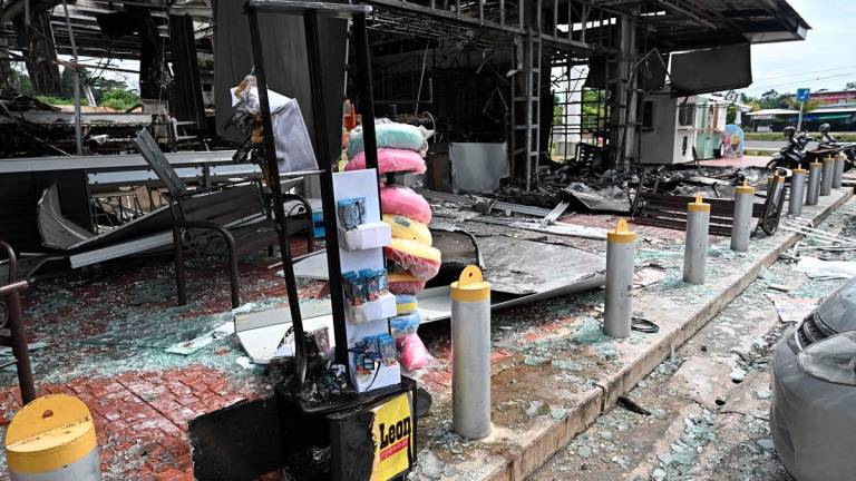 Damage from a fire caused by Cambodian artillery at a 7-11 convenience store is seen at a PTT gas station in the Thai border province of Sisaket province on July 25, 2025. - AFPPix