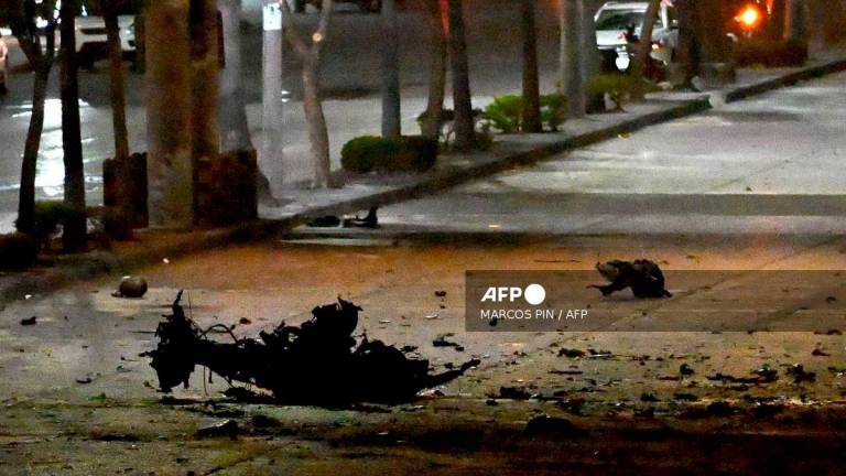 The remains of a suspected car bomb that exploded in front of a shopping center are pictured in the north of Guayaquil, Ecuador on October 14, 2025. Photo by MARCOS PIN / AFP