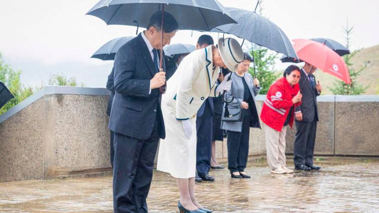 Japan’s Emperor Naruhito (L) and Empress Masako (2nd L) pay tribute at a memorial to commemorate Japanese nationals who died while being detained in Mongolia after the end of World War II - AFPPix