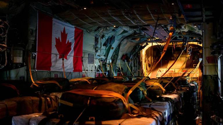 Pallets are prepared on a Royal Canadian Air Force CC-130 Hercules transport aircraft before airdropping some of approximately 21,600 lbs of humanitarian aid over the Gaza Strip, at Queen Alia International Airport in Amman, Jordan August 4, 2025. - Corporal Marc-Andre Leclerc/Canadian Forces/Handout via REUTERSPIX
