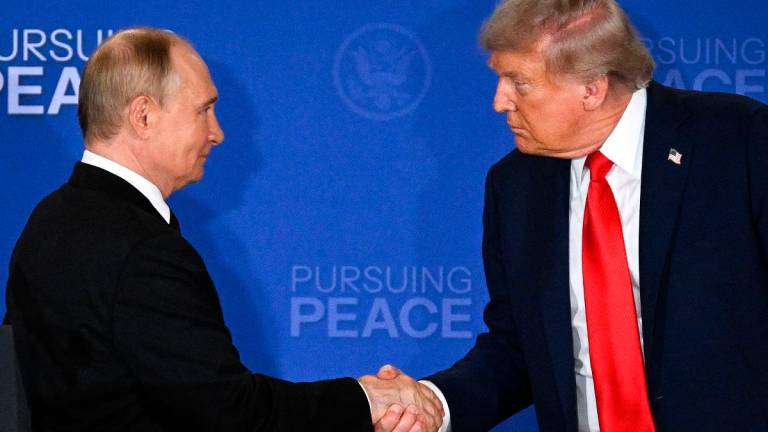 US President Donald Trump (R) and Russian President Vladimir Putin shake hands at the end of a joint press conference after participating in a US-Russia summit on Ukraine at Joint Base Elmendorf-Richardson in Anchorage, Alaska, on August 15, 2025. - Drew ANGERER / AFP