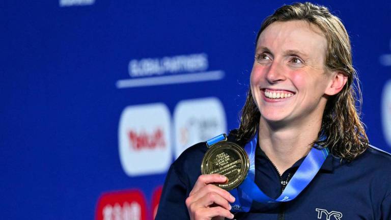 Gold medallist US' swimmer Katie Ledecky celebrates on the podium of the women's 800m freestyle swimming event during the 2025 World Aquatics Championships in Singapore on August 2, 2025. - AFPPIX