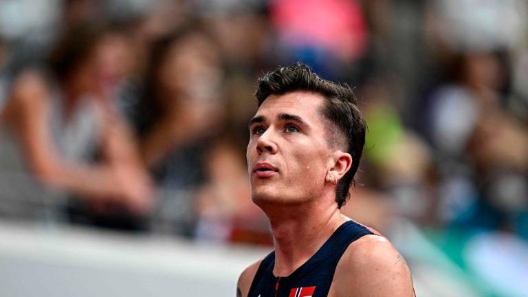 Norway’s Jakob Ingebrigtsen reacts after competing in the men’s 1500m heats during the World Athletics Championships in Tokyo on September 14, 2025. - Jewel SAMAD / AFP