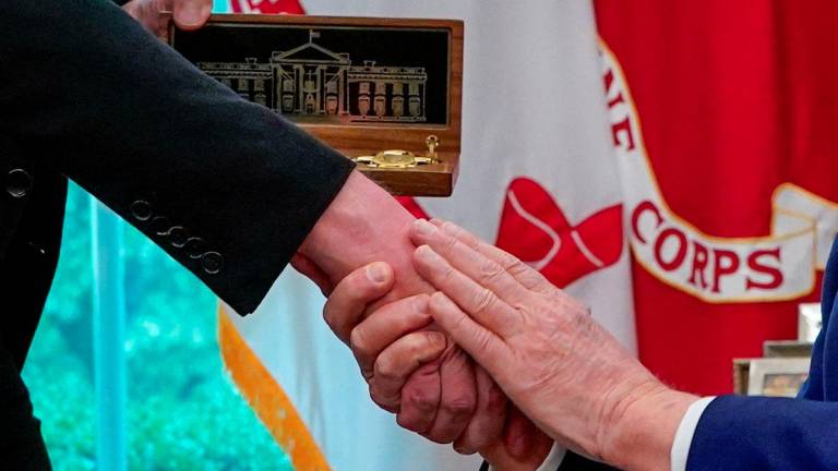 Elon Musk shakes hands with U.S. President Donald Trump as he receives a golden key from him at a press conference in the Oval Office at the White House, in Washington, D.C., U.S., May 30, 2025. - REUTERSPIX