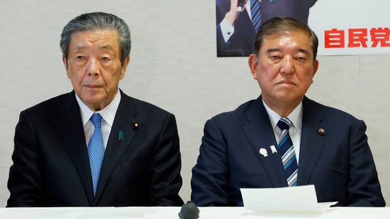 Japan’s Prime Minister Shigeru Ishiba (R) and secretary-general Hiroshi Moriyama (L) attend a meeting of the Liberal Democratic Party (LDP) executive committee at the party’s headquarters in Tokyo on September 2, 2025. - JIJI PRESS / AFP
