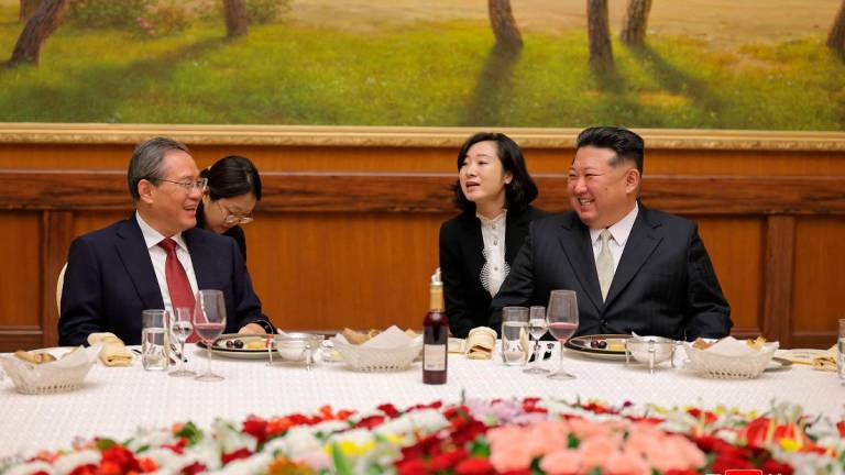 North Korean leader Kim Jong Un (R) speaking with Chinese Premier Li Qiang (L) at the headquarters of the Central Committee of the Workers’ Party of Korea in Pyongyang. - AFP PHOTO/KCNA VIA KNS