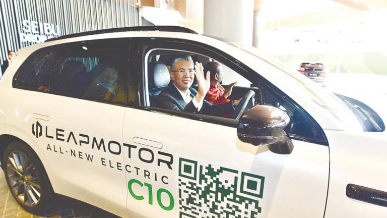 Tengku Zafrul taking a test drive of the Leapmotor C10.