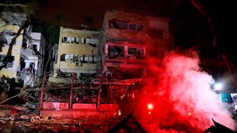 An emergency vehicle is seen near the rubble of a damaged building in the Israeli city of Tel Aviv after a fresh barrage of Iranian rockets on June 16, 2025. AFPpix