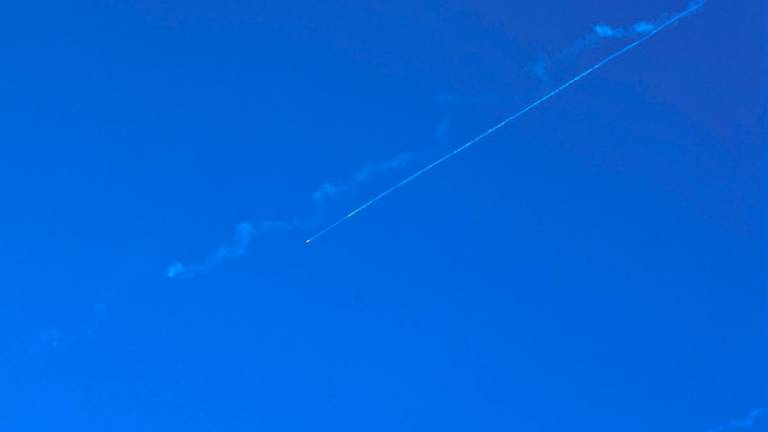 A missile fired from Iran leaves a trail in the sky above nablus city in the occupied West Bank on June 19, 2025. - Zain JAAFAR / AFP