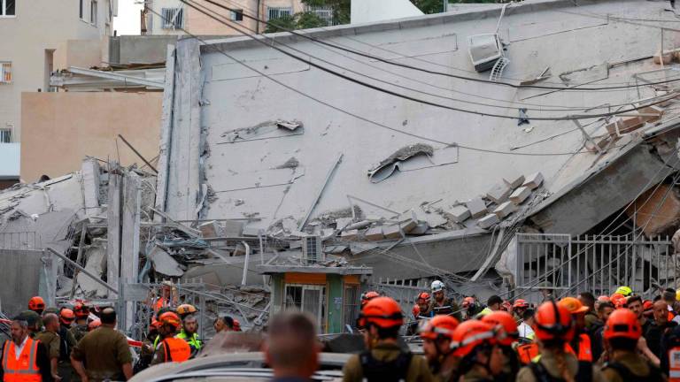 Israeli rescuers search through the rubble at the site of an Iranian missile strike in Bnei Brak on June 16, 2025. Iran unleashed a barrage of missile strikes on Israeli cities early on June 16, after Israel struck military targets deep inside Iran, with both sides threatening further devastation. AFP