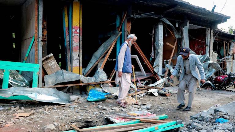 Residents assess the damage of their shops after they were hit in an Indian strike, following the ceasefire announcement between India and Pakistan, in Jura village in Neelum Valley, Pakistani Kashmir, May 12, 2025. - REUTERSPIX