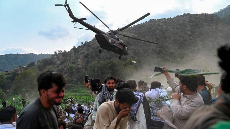 A military helicopter airlifts injured Afghans after earthquakes at Mazar Dara village in Nurgal district, Kunar province, in Eastern Afghanistan, on September 1, 2025. - AFPPIX