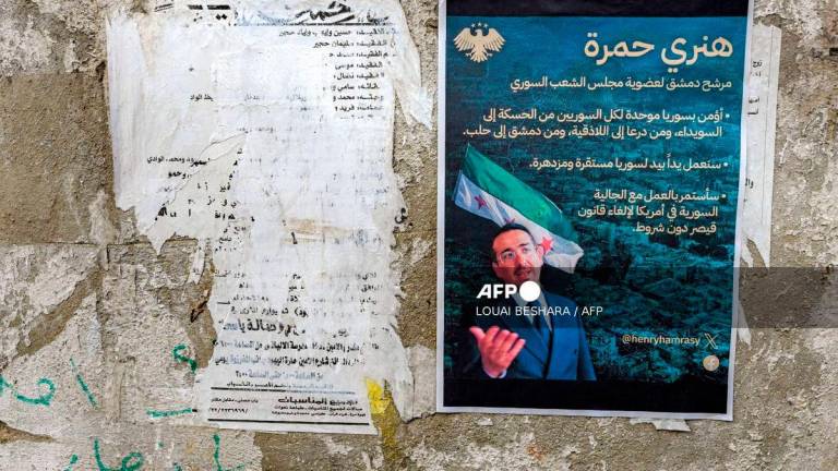 Election posters of Henry Hamra, a Syrian-American parliamentary candidate who is the son of the country's last rabbi and who if elected will be the first Jewish representative in the Syrian parliament since the late 1940s, are displayed on a wall along an alley in the Jewish quarter of the old city of Damascus on October 3, 2025, ahead of the upcoming vote on October 5. - AFP